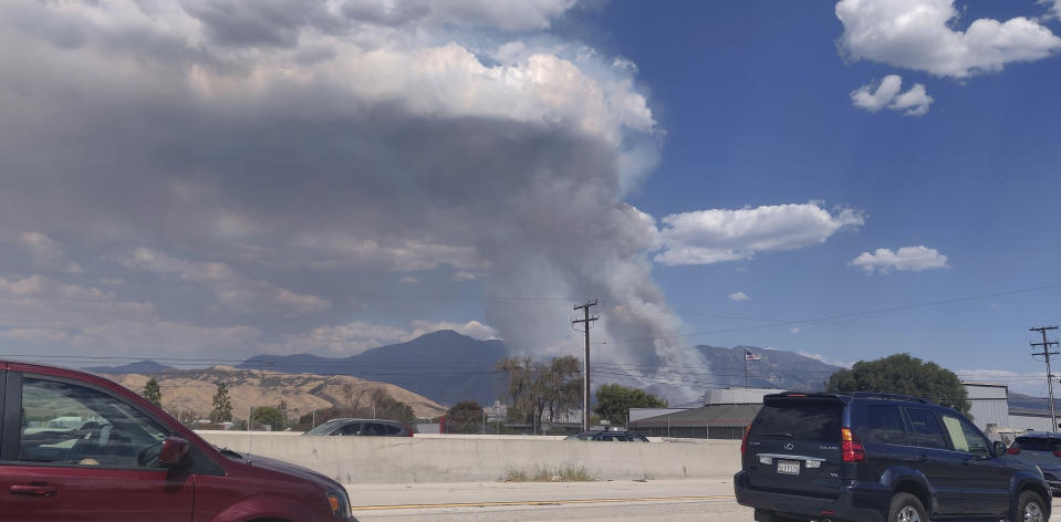 A plume of smoke from the El Dorado Fire is seen from the Interstate 10 in Loma Linda, Calif., Saturday, Sept. 5, 2020. In Southern California, a fast-moving fire in the foothills of Yucaipa has prompted evacuation orders for Oak Glen, a farm community that just opened its apple-picking season to the public. Cal Fire's San Bernardino unit said the fire has scorched at least 800 acres and was burning at a "moderate to dangerous" rate of spread. (AP Photo/Ringo H.W. Chiu)