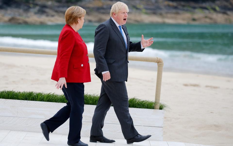Prime Minister Boris Johnson walks next to German Chancellor Angela Merkel - REUTERS/Phil Noble/Pool