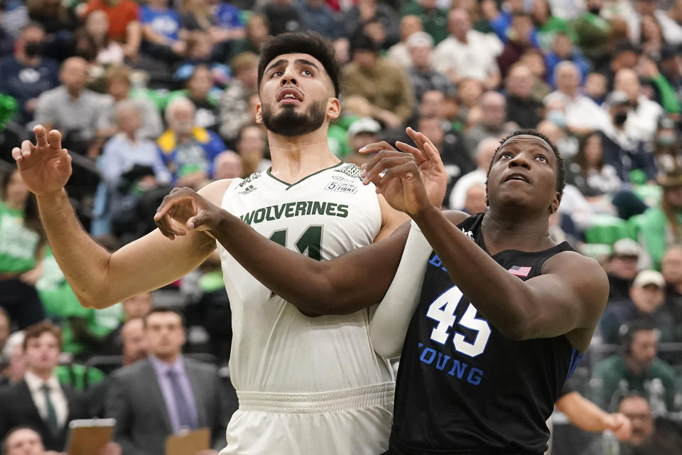 Utah Valley center Fardaws Aimaq (11) and BYU forward Fousseyni Traore (45) battle for position under the boards in the first half during an NCAA college basketball game Wednesday, Dec. 1, 2021, in Orem, Utah. (AP Photo/Rick Bowmer)