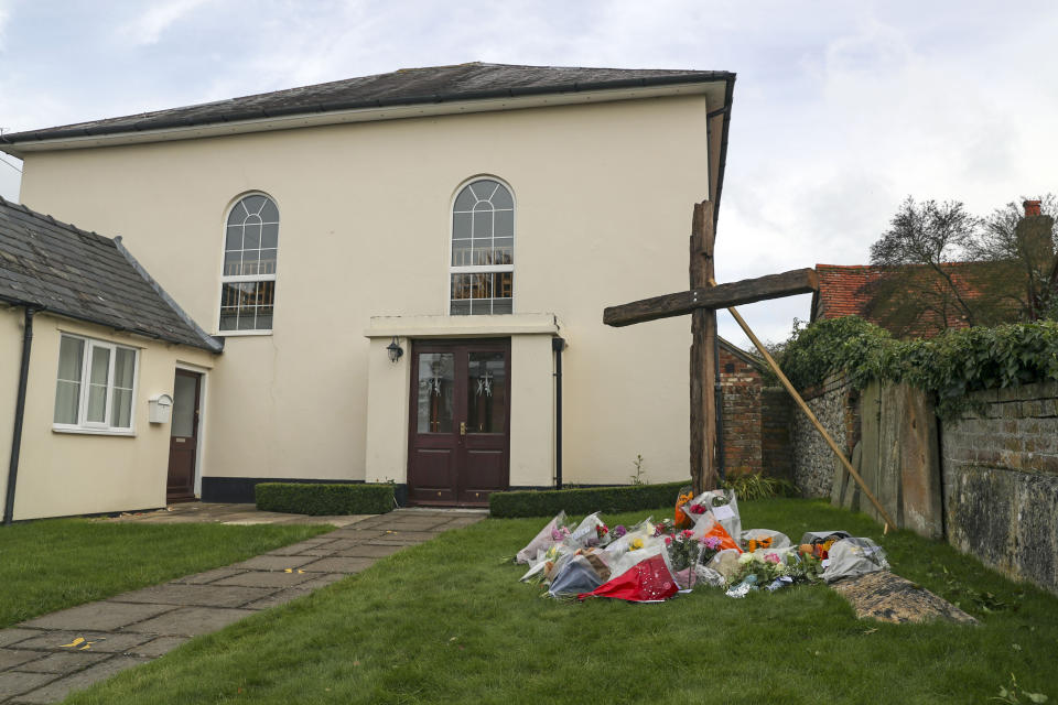 Floral tributes laid in front of a cross erected outside Chinnor Community Church in Chinnor, Oxfordshire, in memory of Zoe Powell, 29, and her three children - Phoebe, eight, Simeon, six, and Amelia, four - who were killed in a car accident on the A40 near Oxford on Monday night.