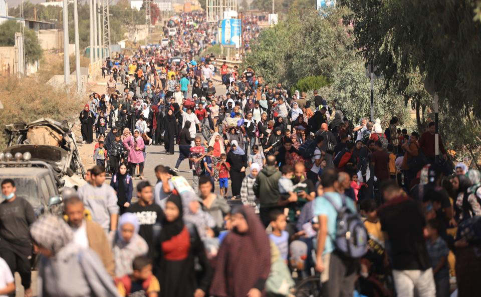 Palestinians families fleeing Gaza City and other parts of northern Gaza towards the southern areas, walk along a highway on November 9, 2023, amid the ongoing battles between Israel and the Palestinian Islamist group Hamas. Thousands of Palestinians were fleeing on foot November 8, in a surge away from the fighting and intense bombardment in Gaza as Israel said it was tightening the 