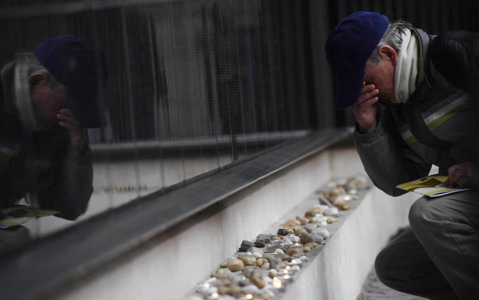 <p>A man prays at the Victims’ Memorial Wall bearing names of victims during a commemoration marking the International Holocaust Remembrance Day in the Holocaust Memorial Centre in Budapest, Hungary, Friday, Jan. 26, 2018, on the eve of the actual day.(Photo: Tibor Illyes/MTI via AP) </p>