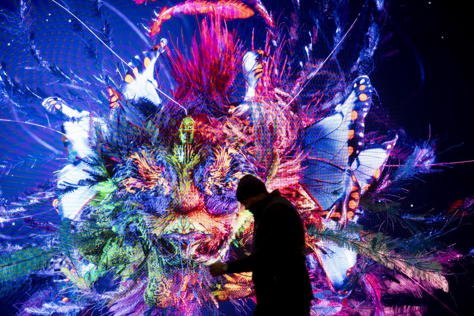 ftse A man walks in front of a screen with a artificial intelligence generated artwork by media artist Refik Anadol, inside the Congress Center where the World Economic Forum take place in Davos, Switzerland, Sunday, Jan. 14, 2024. The annual meeting of the World Economic Forum is taking place in Davos from Jan. 15 until Jan. 19, 2024. (AP Photo/Markus Schreiber)