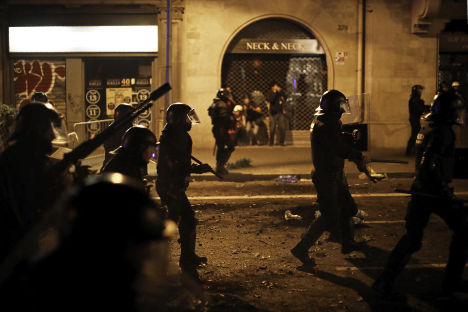 Police charges against protestors during clashes in Barcelona, Spain, Thursday, Oct. 17, 2019. Catalonia's separatist leader vowed Thursday to hold a new vote to secede from Spain in less than two years as the embattled northeastern region grapples with a wave of violence that has tarnished a movement proud of its peaceful activism. (AP Photo/Emilio Morenatti)