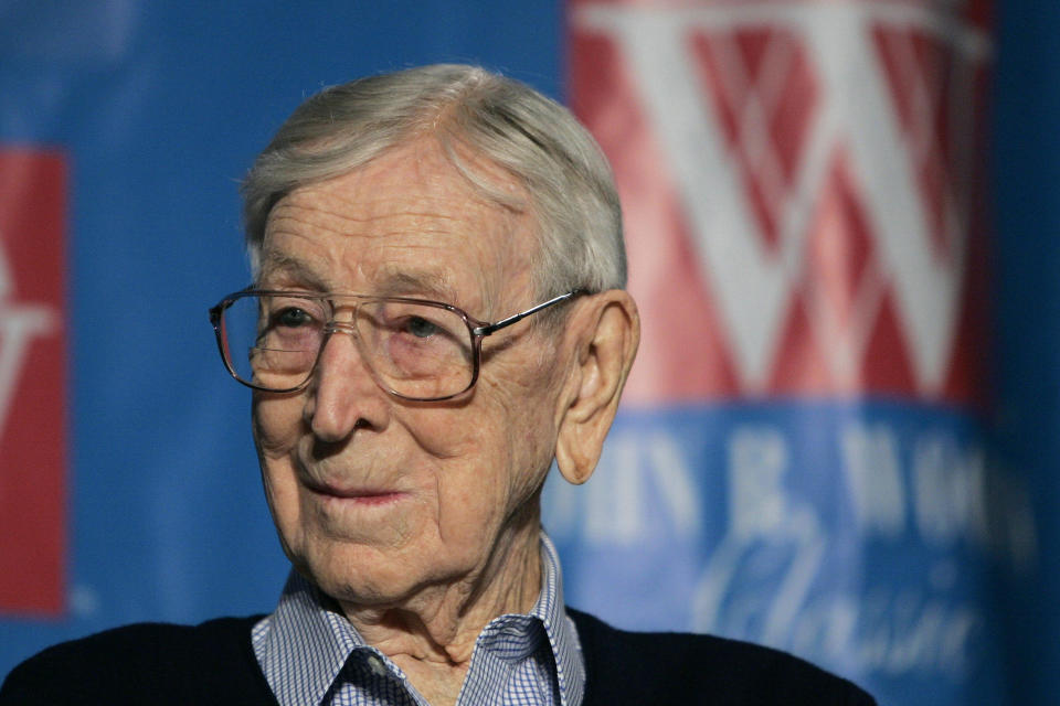 FILE - Former UCLA basketball coach John Wooden listens during a news conference Friday, Dec. 9, 2005, in Anaheim, Calif., about Wooden Classic basketball tournament. The U.S. Postal Service unveils a stamp for John Wooden, who coached UCLA to a record 10 national basketball championships, outside Pauley Pavilion on the first day of issue, Saturday, Feb. 24, 2024. (AP Photo/Chris Carlson, File)