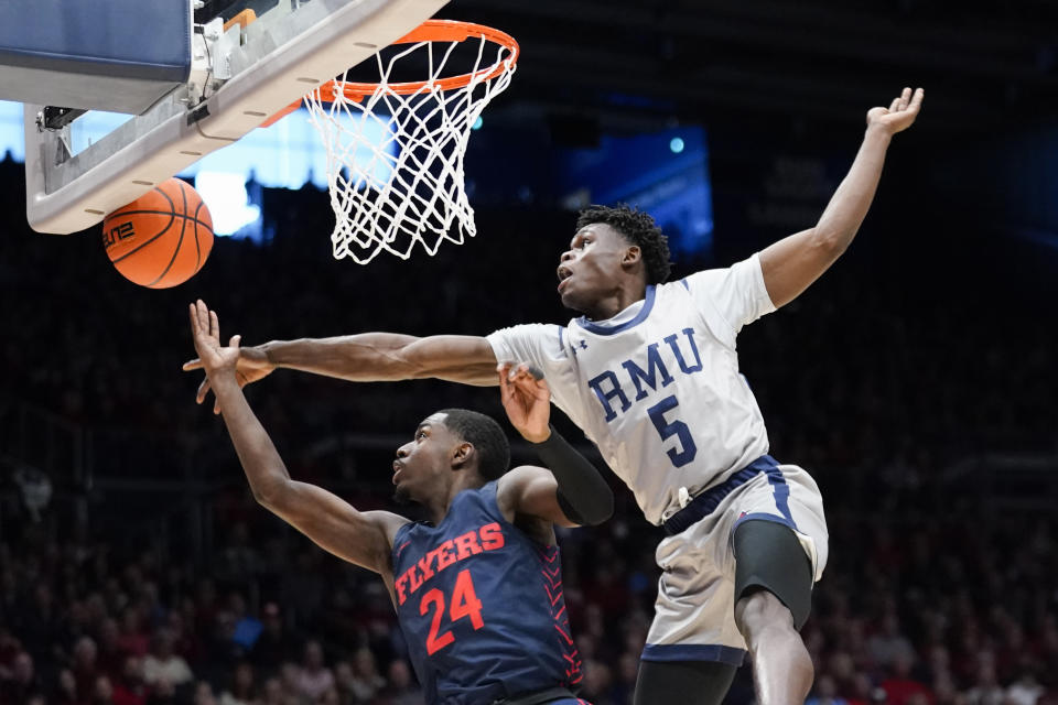 Robert Morris guard Enoch Cheeks (5) blocks a shot attempt from Dayton guard Kobe Elvis (24) during the first half of an NCAA college basketball game, Saturday, Nov. 19, 2022, in Dayton, Ohio. (AP Photo/Joshua A. Bickel)