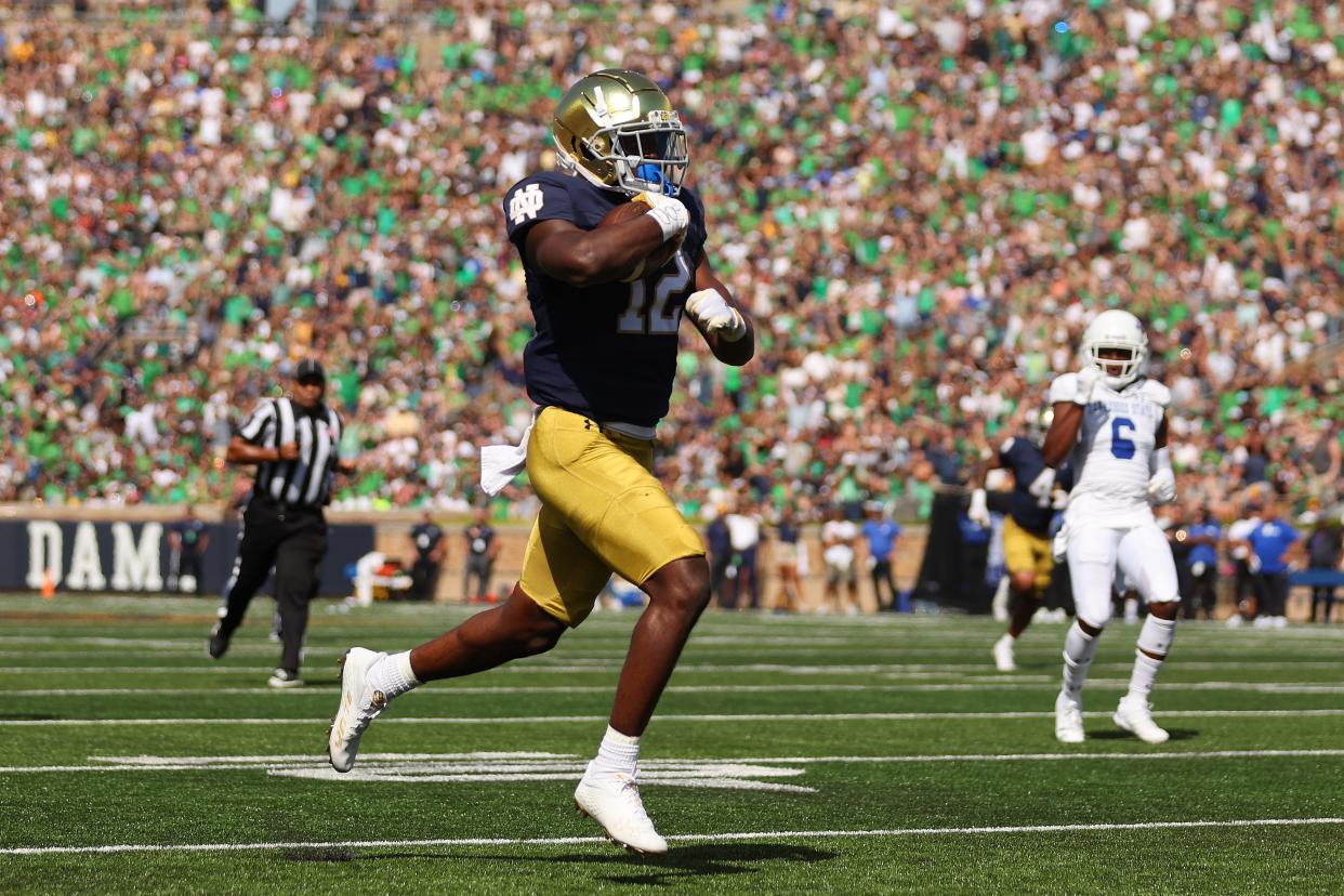 SOUTH BEND, INDIANA - SEPTEMBER 02: Jeremiyah Love #12 of the Notre Dame Fighting Irish runs into the endzone for a touchdown against the Tennessee State Tigers during the first half at Notre Dame Stadium on September 02, 2023 in South Bend, Indiana. (Photo by Michael Reaves/Getty Images)