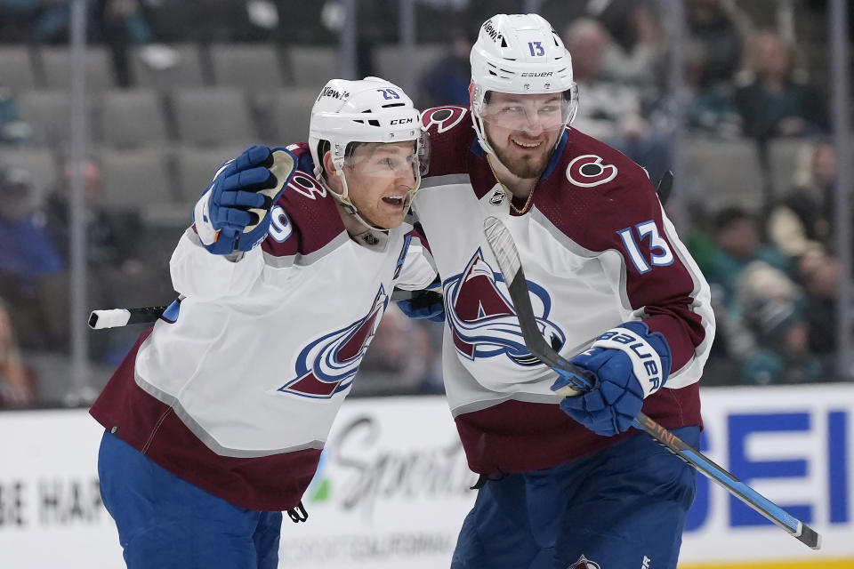 Colorado Avalanche center Nathan MacKinnon (29) celebrates with Valeri Nichushkin (13) after scoring in overtime against the San Jose Sharks during an NHL hockey game Tuesday, April 4, 2023, in San Jose, Calif. Colorado won 4-3 in overtime. (AP Photo/Tony Avelar)