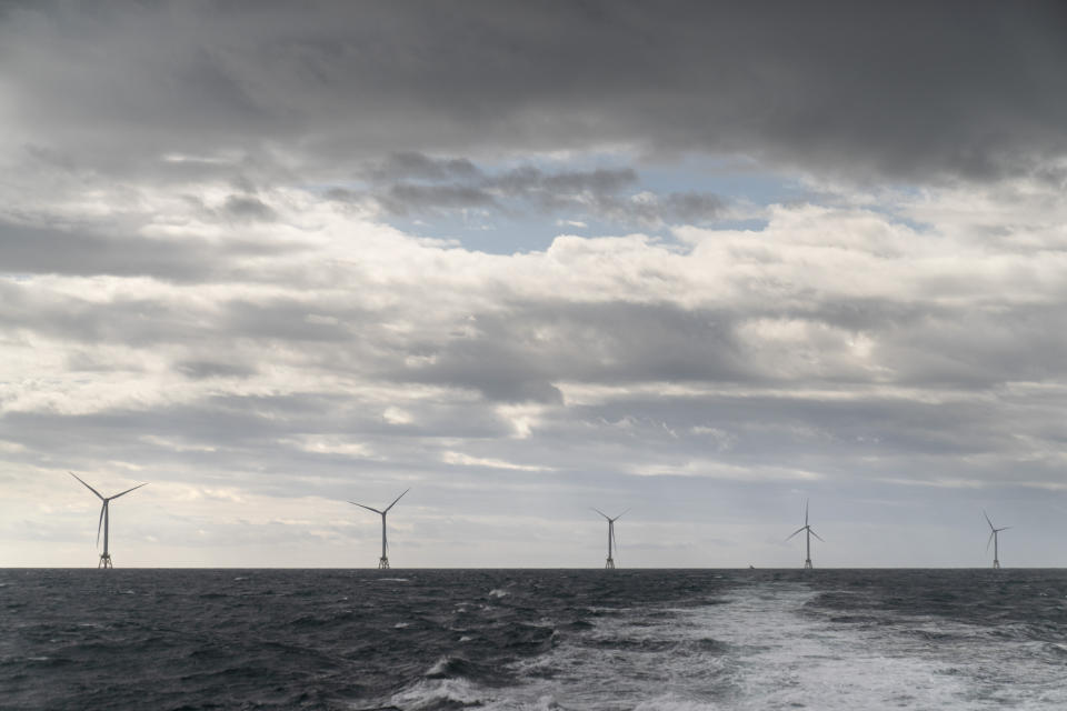 FILE - The five turbines of America's first offshore wind farm, owned by the Danish company, Orsted, are seen from a tour boat off the coast of Block Island, R.I., Oct. 17, 2022. Orsted, one of Europe's most fossil fuel-intensive energy companies, transformed completely in little more than a decade by doubling down on offshore wind. (AP Photo/David Goldman, File)