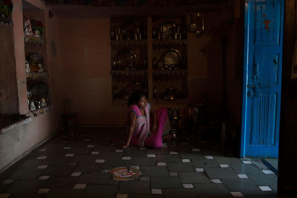 Arti Khatik sits on the floor of her mother-in-law’s house near Changedi, Udaipur, Rajasthan, India, where she has lived since moving in with her husband at age 14. July 2016. (Photo: Rafael Fabrés)