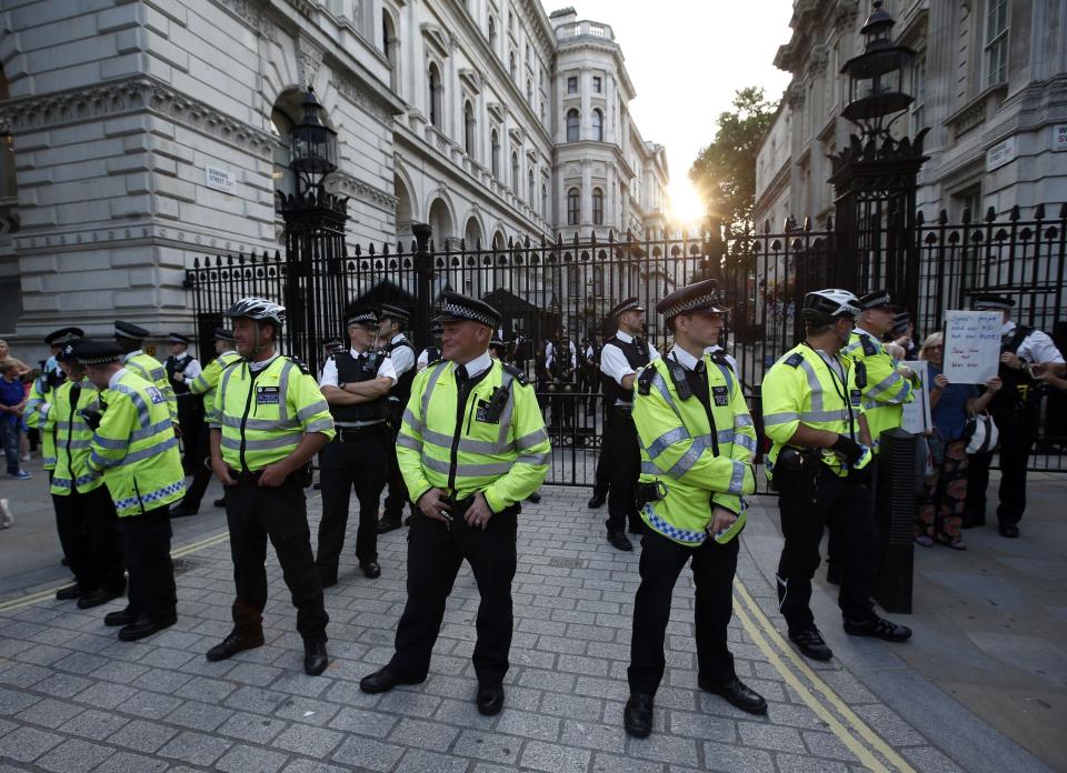 Police stand guard outside Downing Street during an event organised by Stop the War Coalition to protest against potential UK involvement in the Syrian conflict in London.