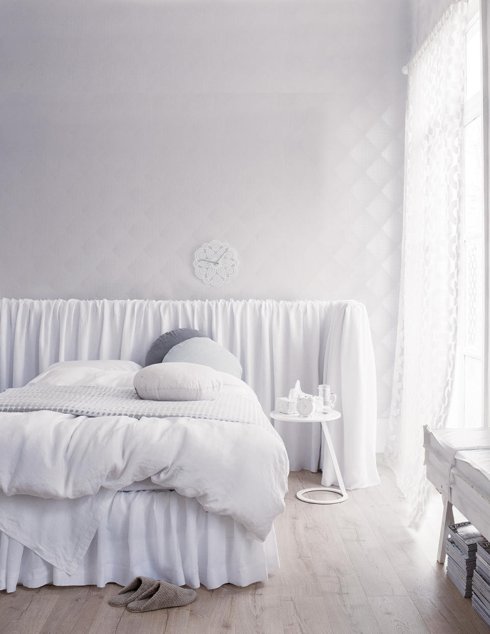 white bedroom with textured throw on the bed