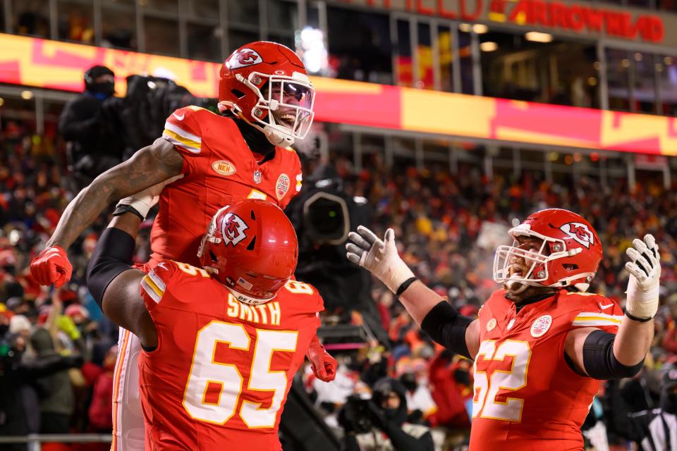 Kansas City Chiefs wide receiver Rashee Rice, in air, Chiefs guard Trey Smith (65) and Chiefs guard Joe Thuney (62) celebrate during the first half of an NFL wild-card playoff football game against the Miami Dolphins, Saturday, Jan. 13, 2024 in Kansas City, Mo.