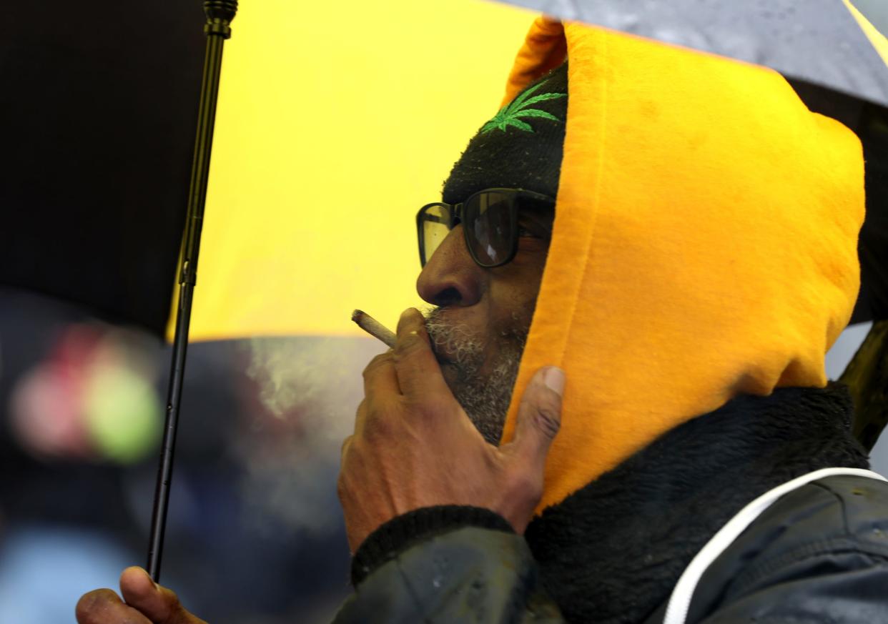 Richard Clement, 66 of Detroit smokes a joint while standing to the side listening to some of the various speakers at Hash Bash 2023 at the Diag on the campus of the University of Michigan in Ann Arbor on Saturday, April 1, 2023.