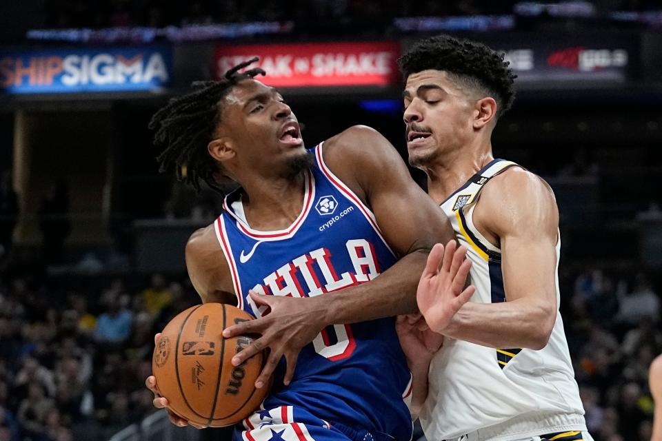 Philadelphia 76ers' Tyrese Maxey (0) goes to the basket against Indiana Pacers' Ben Sheppard during the first half of an NBA basketball game Thursday, Jan. 25, 2024, in Indianapolis. (AP Photo/Darron Cummings)
