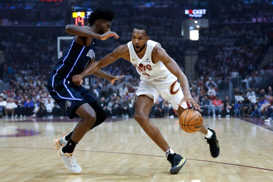 Cleveland Cavaliers forward <a class="link " href="https://sports.yahoo.com/nba/players/6514/" data-i13n="sec:content-canvas;subsec:anchor_text;elm:context_link" data-ylk="slk:Evan Mobley;sec:content-canvas;subsec:anchor_text;elm:context_link;itc:0">Evan Mobley</a> (4) drives against Orlando Magic forward <a class="link " href="https://sports.yahoo.com/nba/players/5768/" data-i13n="sec:content-canvas;subsec:anchor_text;elm:context_link" data-ylk="slk:Jonathan Isaac;sec:content-canvas;subsec:anchor_text;elm:context_link;itc:0">Jonathan Isaac</a>, left, during the first half of Game 2 of an NBA basketball first-round playoff series, Monday, April 22, 2024, in Cleveland. (AP Photo/Ron Schwane)