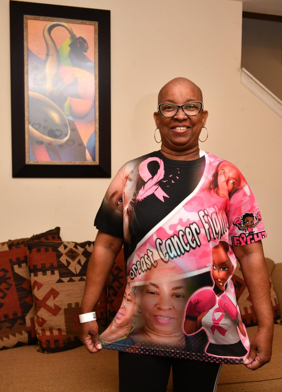 Tina Davis proudly displays a t-shirt commemorating her fight against breast cancer.