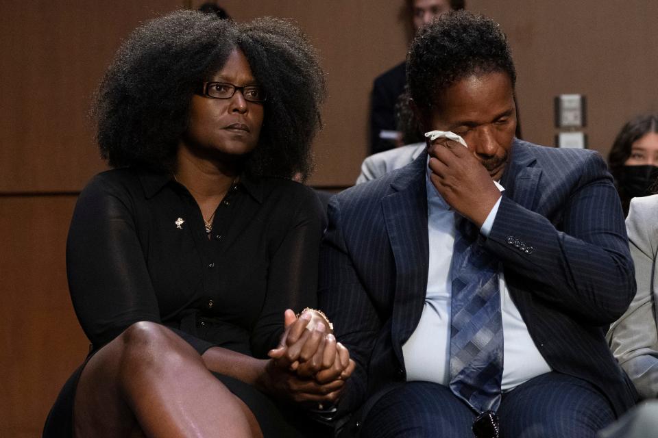 Raymond Whitfield, right, reacts as his brother Garnell Whitfield, Jr., of Buffalo, N.Y., not pictured, talks about their mother Ruth Whitfield who was killed in the Buffalo Tops supermarket mass shooting during a Senate Judiciary Committee hearing on domestic terrorism, Tuesday, June 7, 2022, on Capitol Hill in Washington. Zeneta Everhart, whose son Zaire Goodman, 20, was shot in the neck during the shooting and survived listens at left. (AP Photo/Jacquelyn Martin) ORG XMIT: DCJM105