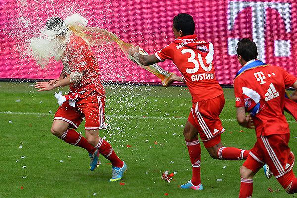 Franck Ribéry of Bayern Munich receives a beer shower from teammate Gustavo following their team's match against Augsburg at the Allianz Arena. Photo: Getty Images