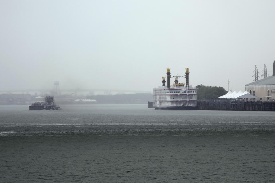 The low water level of the Mississippi River is seen as a tugboat navigates barges around a bend past a paddlewheel boat in New Orleans, Monday, Sept. 25, 2023. (AP Photo/Gerald Herbert)