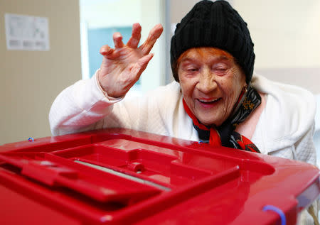 A woman reacts as she casts her vote during European Parliament election in Riga, Latvia, May 25, 2019. REUTERS/Ints Kalnins