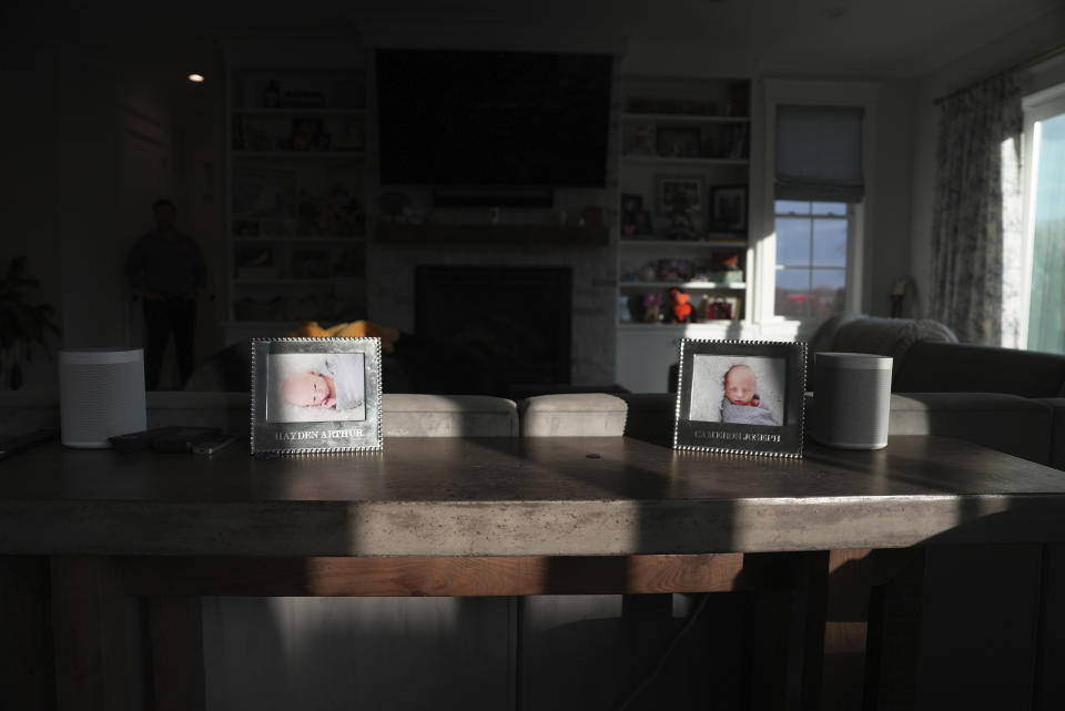 Photos of Hayden Fell and his twin brother, Cameron, sit on a table at home in Bel Air, Md., on Dec. 4, 2023. The Fells knew all about putting infants to sleep on their backs to lower the risk of SIDS. But Hayden was long past the age of SIDS and they’d never heard of sudden unexplained death in childhood, or SUDC, until he died. (AP Photo/Shelby Lum)