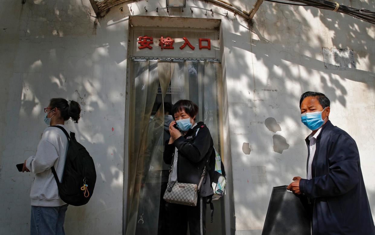 Wei Xiuwen, mother of Chen Mei, centre, heads to the courthouse to attend her child's case in Beijing - Andy Wong/AP