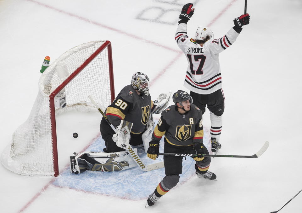 Vegas Golden Knights goalie Robin Lehner (90) is scored on as Chicago Blackhawks' Dylan Strome (17) celebrates and Golden Knights' Nate Schmidt (88) looks on during the second period of an NHL hockey Stanley Cup first-round playoff series, Thursday, Aug. 13, 2020, in Edmonton, Alberta. (Jason Franson/The Canadian Press via AP)