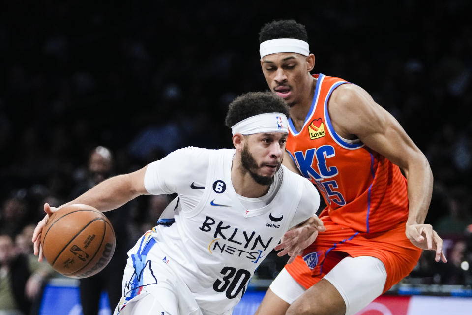 Brooklyn Nets' Seth Curry (30) drives past Oklahoma City Thunder's Darius Bazley, right, during the first half of an NBA basketball game Sunday, Jan. 15, 2023, in New York. (AP Photo/Frank Franklin II)