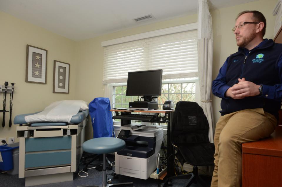 Jacob Stapledon, Community Engagement and Education Program Manager in a medical exam room on the second floor at the Cape and Islands Child Advocacy Center, Children's Cove, in Barnstable on Nov. 6, 2022. Once the center's new building project is complete, the room will be housed on the first floor in a larger space.