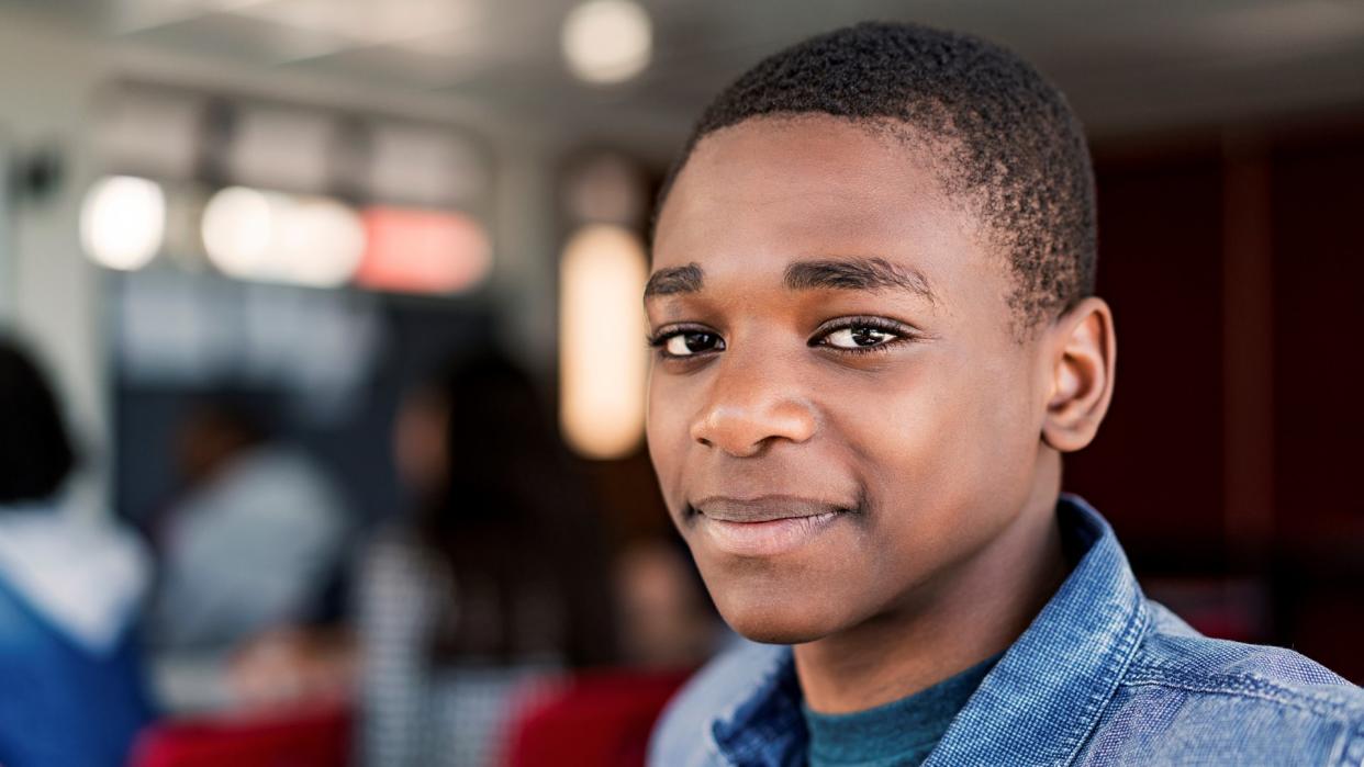 Close-up of confident teenage boy at high school.