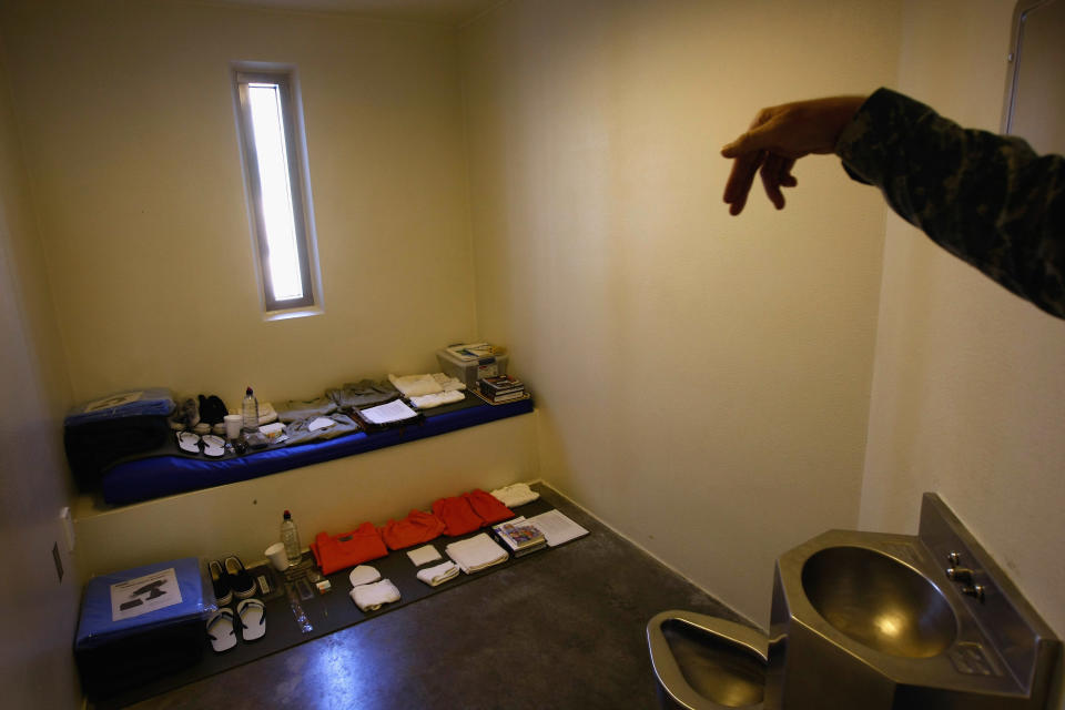 GUANTANAMO BAY, CUBA - OCTOBER 27: A military guard shows a display cell in the maximum security section of the U.S. military prison for 'enemy combatants' on October 27, 2009 in Guantanamo Bay, Cuba. Although U.S. President Barack Obama pledged in his first executive order last January to close the infamous prison within a year's time, the government has been struggling to try the accused terrorists and to transfer them out ahead of the deadline. Military officials at the prison point to improved living standards and state of the art medical treatment available to detainees, but the facility's international reputation remains tied to the 'enhanced interrogation techniques' such as waterboarding employed under the Bush administration.  (Photo by John Moore/Getty Images)