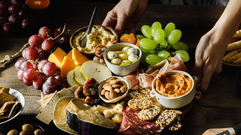 person sets charcuterie board onto table