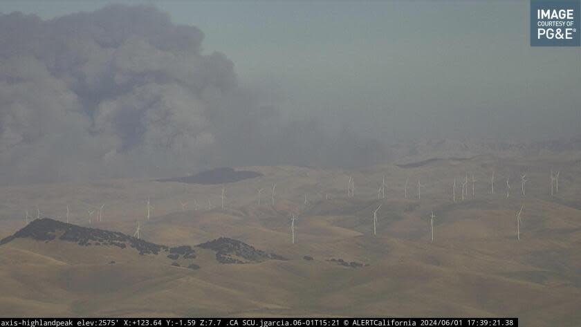 In this image from an AlertCalifornia/UC San Diego monitoring camera, smoke rises from the Corral Fire near the city of Tracy, Calif., Saturday, June 1, 2024. (AlertCalifornia/UC San Diego via AP)