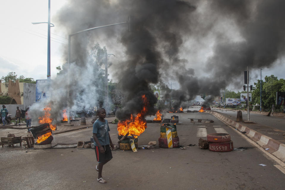 Anti-government protesters burn tires and barricade roads in the capital Bamako, Mali, Friday, July 10, 2020. Thousands marched Friday in Mali's capital in anti-government demonstrations urged by an opposition group that rejects the president's promises of reforms. (AP Photo/Baba Ahmed)