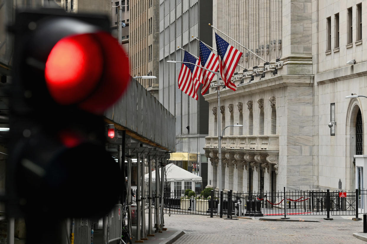 People walk near the New York Stock Exchange at Wall Street on February 24, 2022 in New York. - Wall Street stocks opened sharply lower Thursday, joining a global equity sell-off after Russia&#39;s invasion of Ukraine lifted energy prices and prompted debate on further sanctions. (Photo by ANGELA WEISS / AFP) (Photo by ANGELA WEISS/AFP via Getty Images)