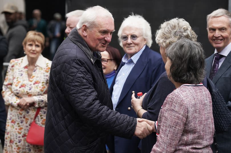 Bertie Ahern arrives for a wreath-laying ceremony at the Memorial to the victims of the Dublin and Monaghan bombings on Talbot Street in Dublin, seen here greeting and shaking hands with people