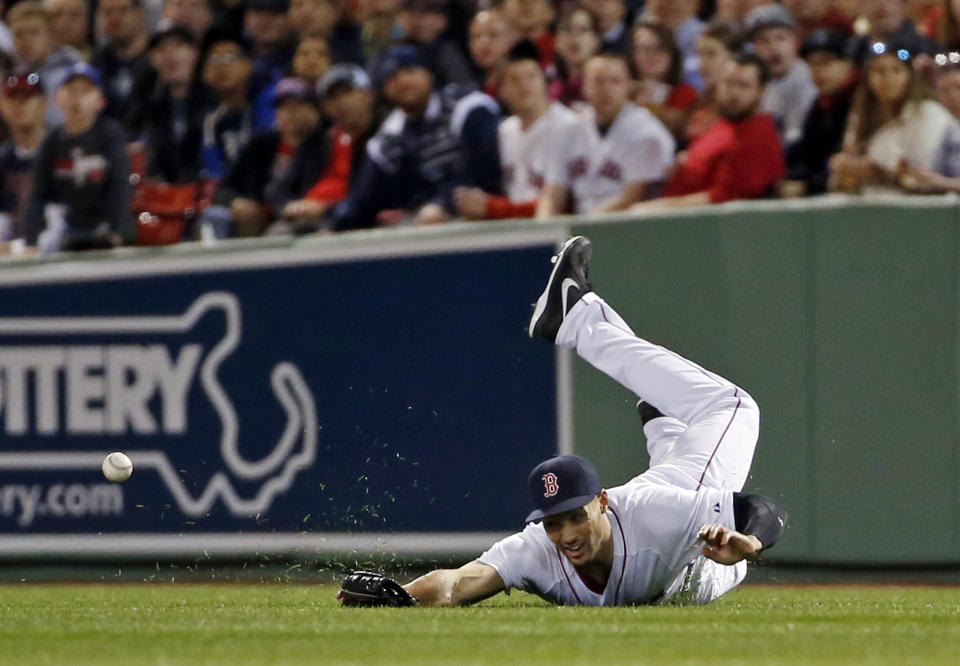 Boston Red Sox right fielder Grady Sizemore dives but cannot catch a single by New York Yankees' Brian Roberts during the third inning of a baseball game at Fenway Park in Boston, Tuesday, April 22, 2014. (AP Photo/Elise Amendola)