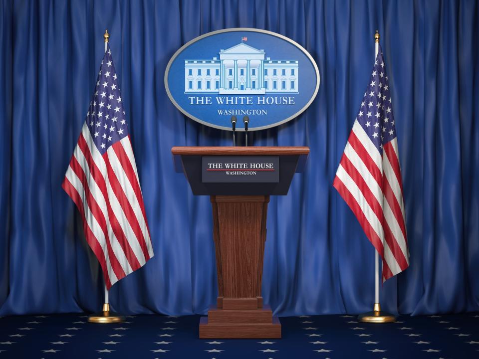 White House podium with flags.