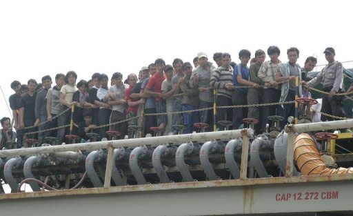 Indonesian authorities evacuate asylum seekers off a tanker in Merak port in April 2012. Australia's parliament neared agreement to transfer boatpeople seeking asylum to Pacific states, with Prime Minister Julia Gillard saying they could be processed offshore within a month
