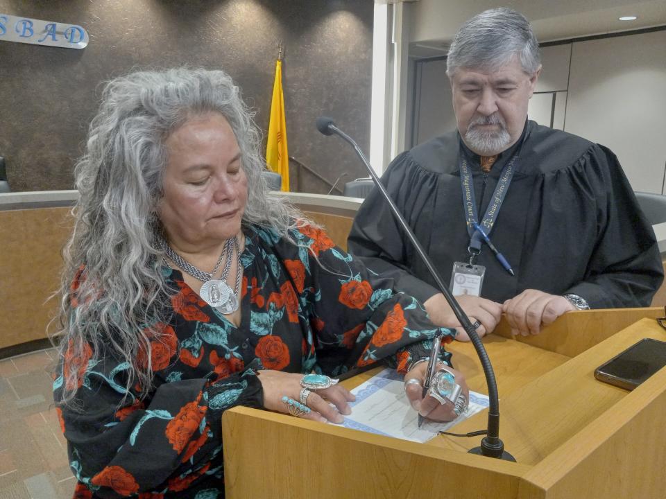 Ward 1 Carlsbad City Councilor Lisa Anaya-Flores signs her oath of office after being sworn in for another four years by Eddy County Magistrate Judge Kellie Calicoat on Dec. 28, 2023 in Carlsbad.