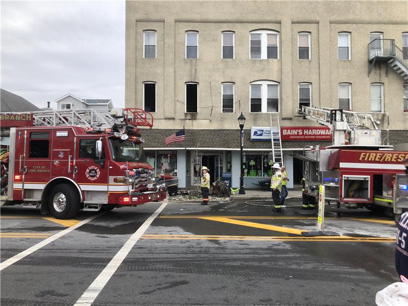 Firefighters mop up after fire in apartments above Bain's Hardware in Sea Bright on Friday, March 10, 2023.