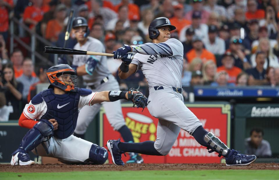 New York Yankees right fielder Juan Soto (22) hits an RBI single during the fifth inning against the Houston Astros at Minute Maid Park.