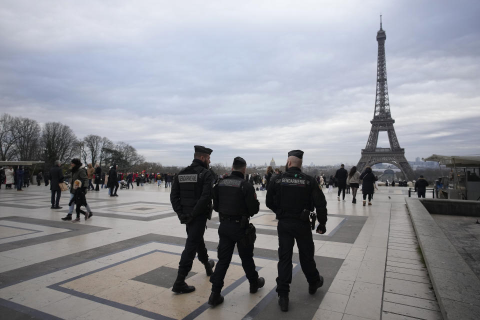 French gendarmes patrol the Trocadero plaza near the Eiffel Tower after a man targeted passersbys late saturday, killing a German tourist with a knife and injuring two others in Paris, Sunday, Dec. 3, 2023. Police subdued the man, a 25-year-old French citizen who had spent four years in prison for a violent offense. After his arrest, he expressed anguish about Muslims dying, notably in the Palestinian territories. (AP Photo/Christophe Ena)