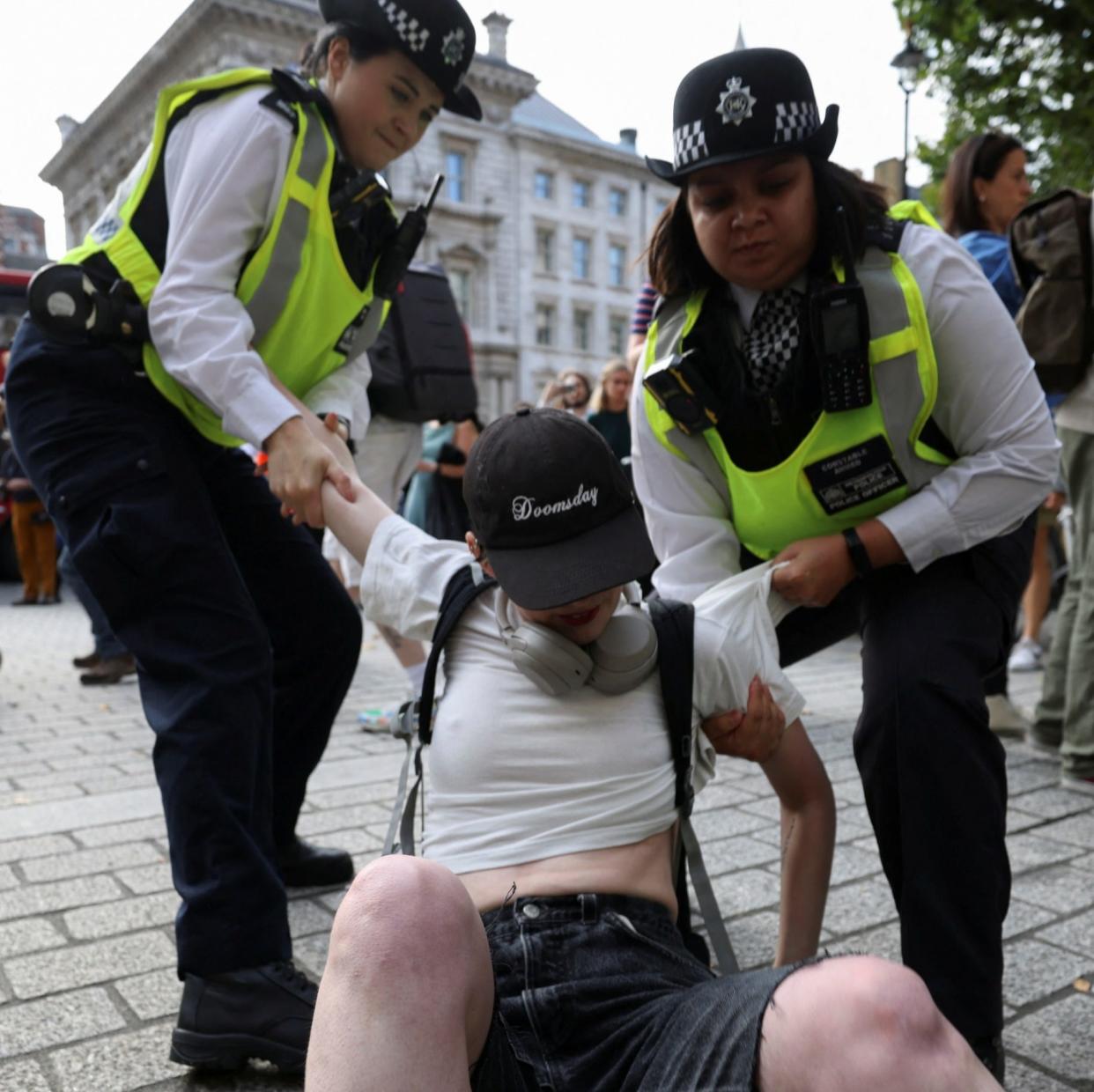 Police officers try to remove a protester