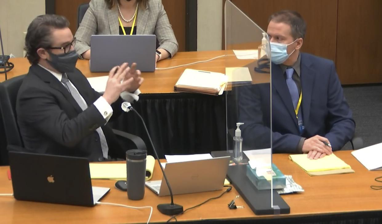 In this screen grab from video, defense attorney Eric Nelson, left, speaks as defendant, former Minneapolis police officer Derek Chauvin, right, listens, Tuesday, April 13, 2021, as Hennepin County Judge Peter Cahill presides over motions in the trial of Chauvin at the Hennepin County Courthouse in Minneapolis, Minn.