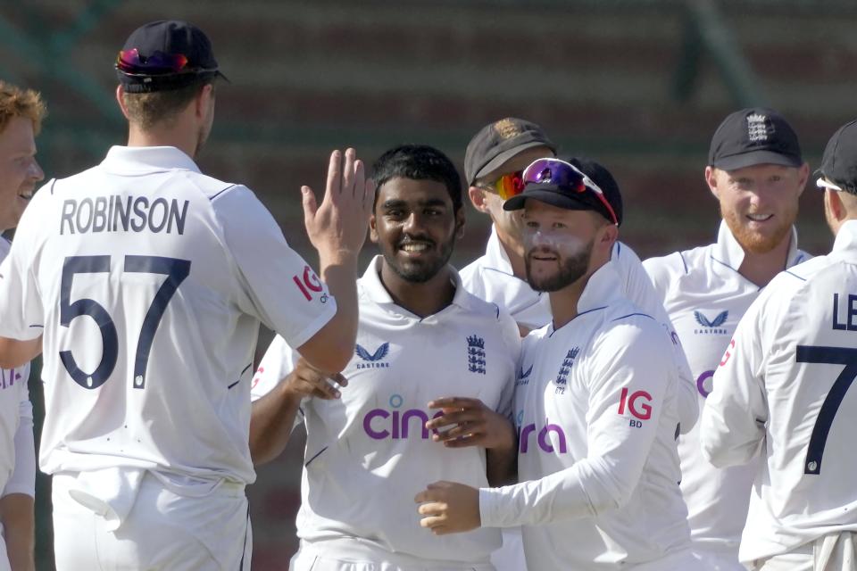 England's Rehan Ahmed, center, celebrates with teammates after taking the wicket of Pakistan's Saud Shakeel during the third day of third test cricket match between England and Pakistan, in Karachi, Pakistan, Monday, Dec. 19, 2022. (AP Photo/Fareed Khan)