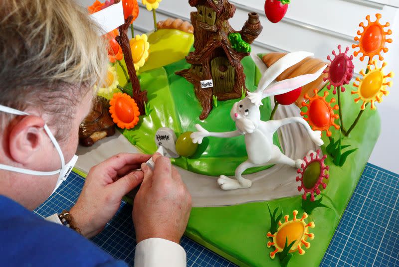 Cake maker Lewis-Anderson puts the finishing touches to a scene with chocolate tree and Easter eggs in La Hulpe