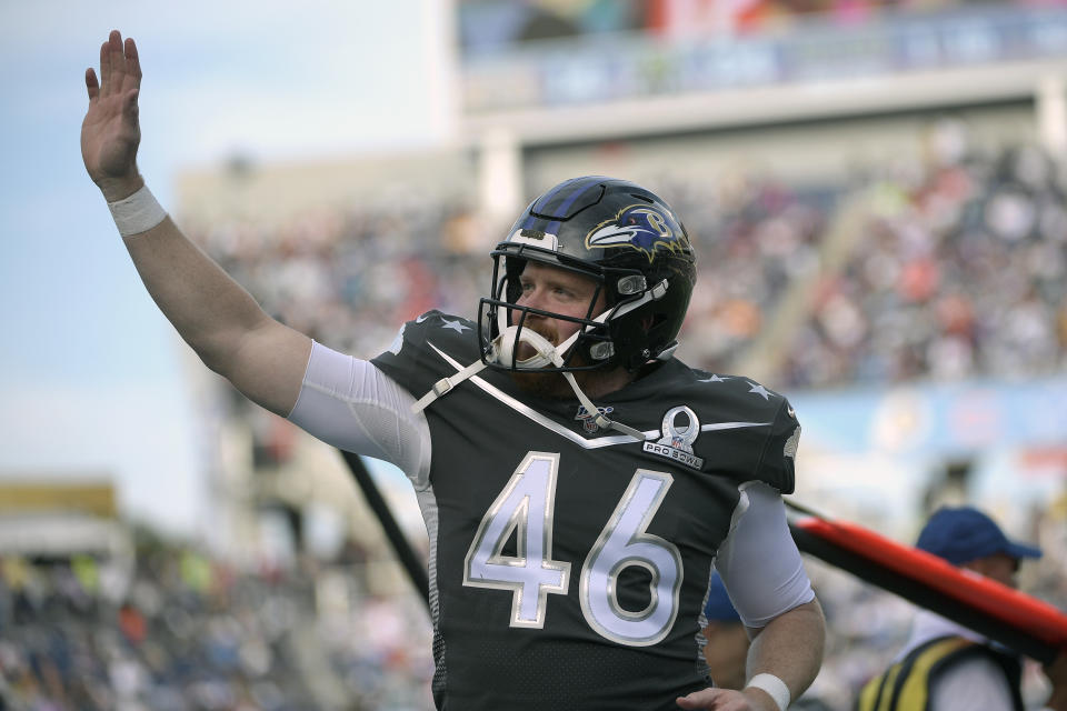 FILE - AFC long snapper Morgan Cox (46), of the Baltimore Ravens, waves to fans in the stands after the first half of the NFL Pro Bowl football game against the NFC in Orlando, Fla., in this Sunday, Jan. 26, 2020, file photo. Ravens general manager Eric DeCosta has already started making some of the tough decisions he believes can help Baltimore negotiate the leap from playoff qualifier to Super Bowl champion. After releasing running back Mark Ingram and quarterback Robert Griffin III last week, DeCosta announced Monday, Jan. 25, 2020, that the Ravens won't re-sign All-Pro long snapper Morgan Cox, the initial component of the highly successful placekicking trio that includes holder Sam Koch and second-team All-Pro Justin Tucker, the most accurate field goal kicker in NFL history.(AP Photo/Phelan M. Ebenhack)