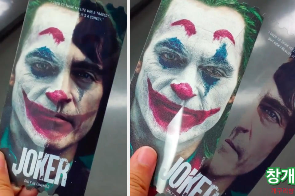 Movie promotion card for "Joker" with image of character's face partially covered by a flap revealing actor's face beneath
